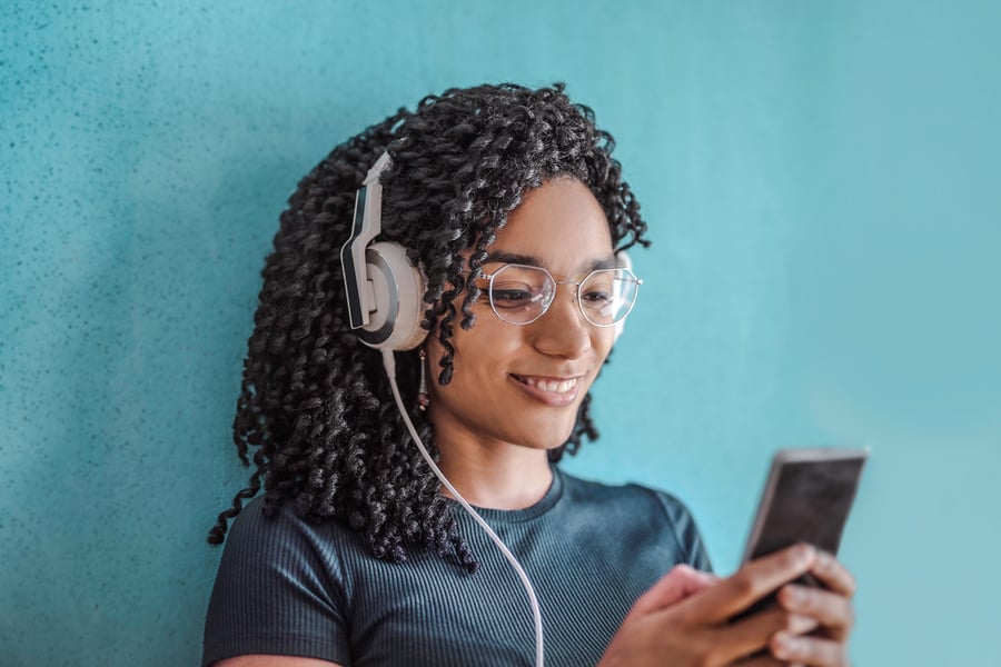 Woman in Black Crew Neck Shirt Wearing White Headphones